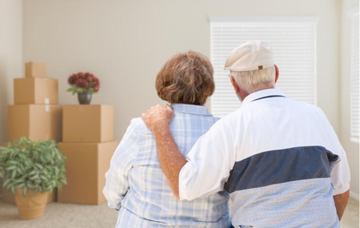 A senior couple reflecting on their house as they pack up to move out