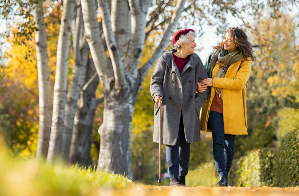 A woman out for a walk with her elderly mother.