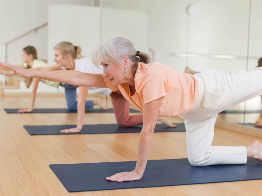 A group of seniors is exercising to strengthen their balance.