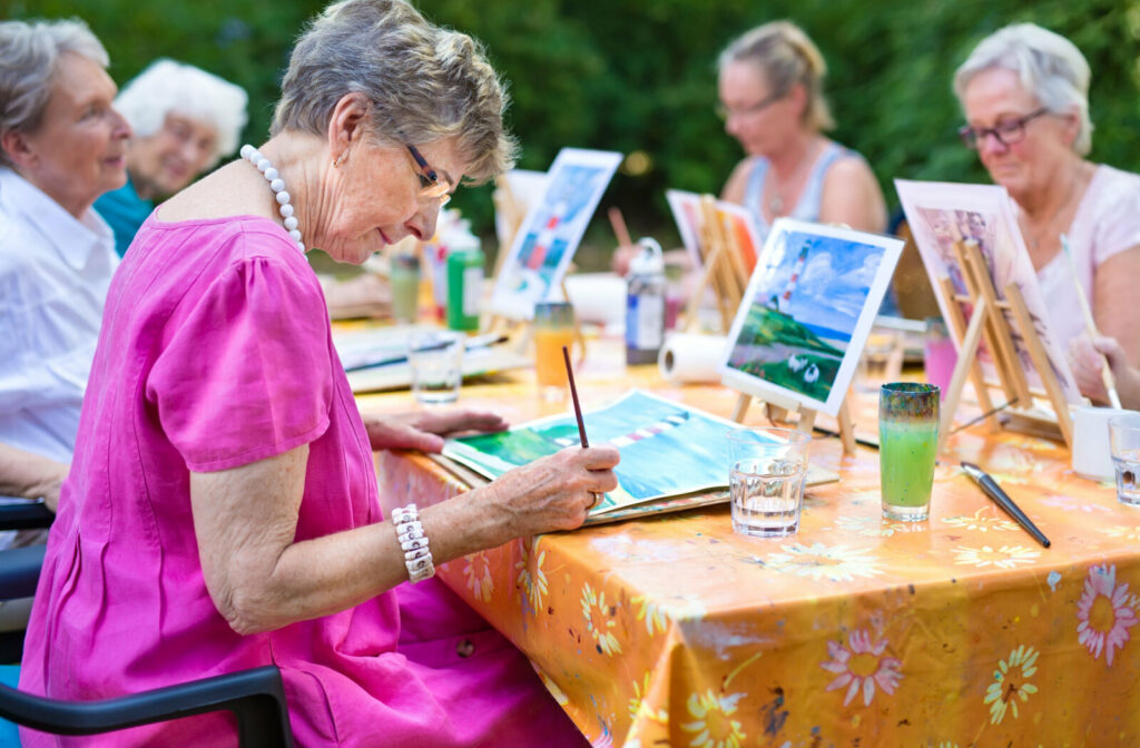Group of senior women have drawing lesson in senior living community.