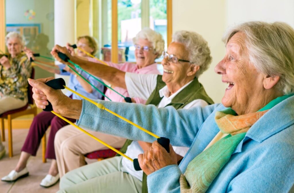 A group of senior women exercising together with resistance bands.