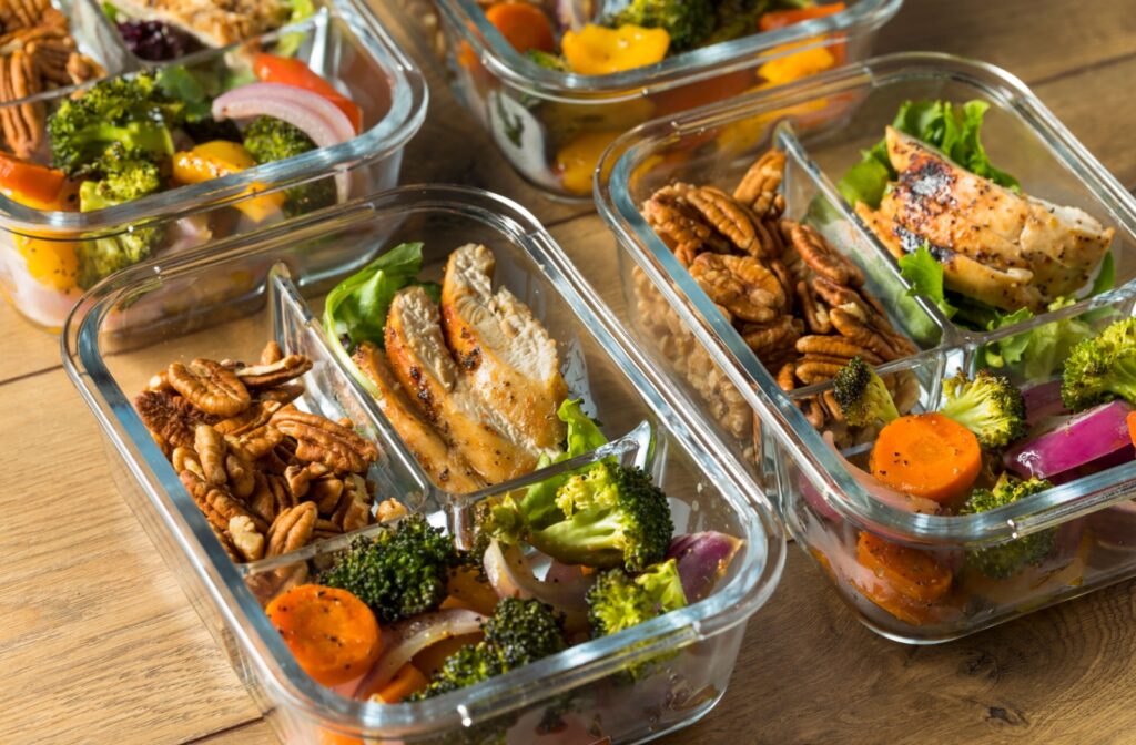 A close-up image of several glass containers with prepared meals for an older adult on the keto diet.