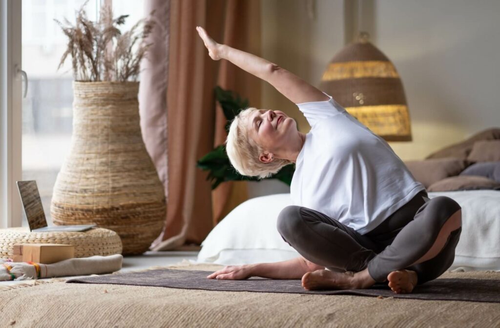 Woman doing stretching yoga side bend at home
