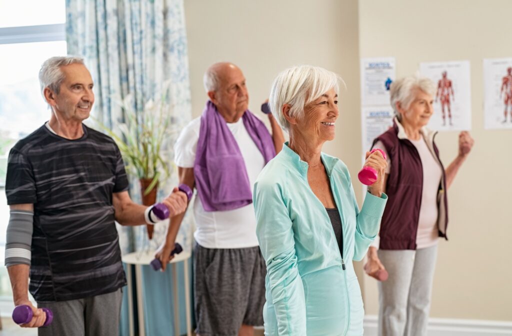 A group of senior residents participate in a light exercise class.