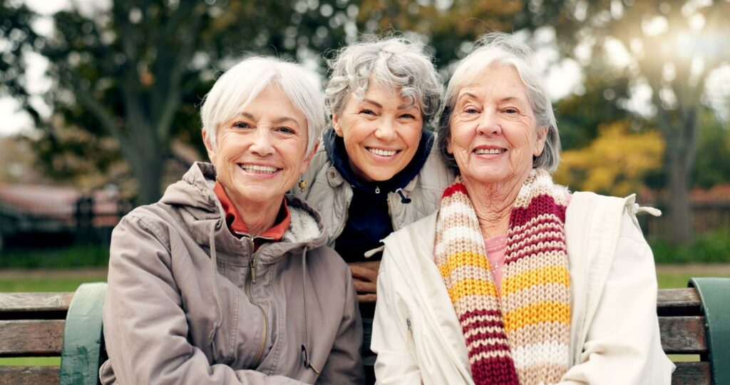 three seniors smile at the camera