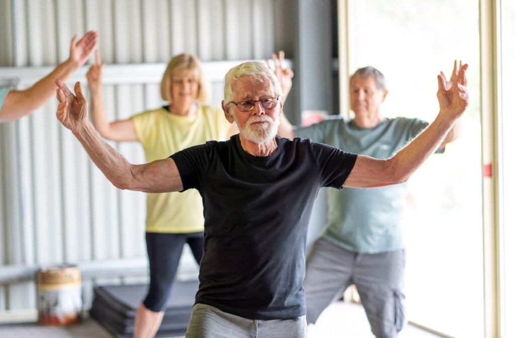 A senior participates in a tai chi class, a light form of exercise that's easy on the joints.
